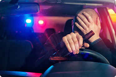 A man drinking liquor while driving, with police chasing him - Matthew P. Kelley, Attorney at Law